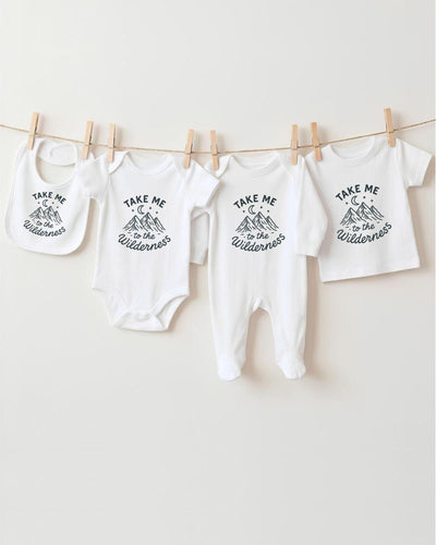 A collection of baby clothes, including onesies and bibs, hanging on a clothesline.