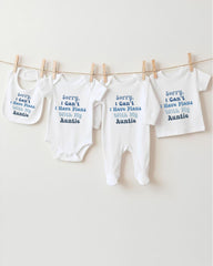 a row of baby clothes hanging on a clothesline, with each piece of clothing having a different message printed on it.
