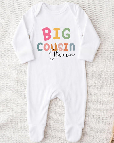A white bodysuit with the text "BIG COUSIN Olivia" printed on it.