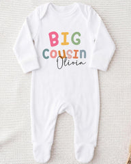 A white onesie with the text "BIG COUSIN Olivia" printed on it.