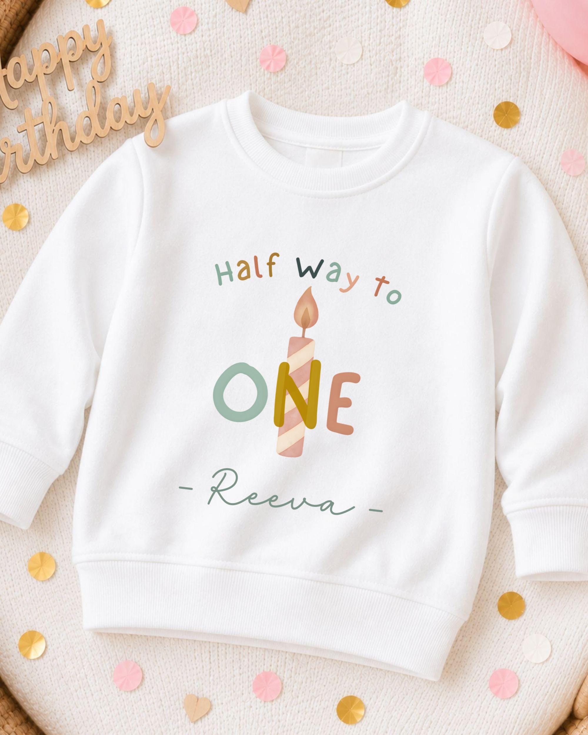 A white sweatshirt with a birthday message printed on it, surrounded by confetti.