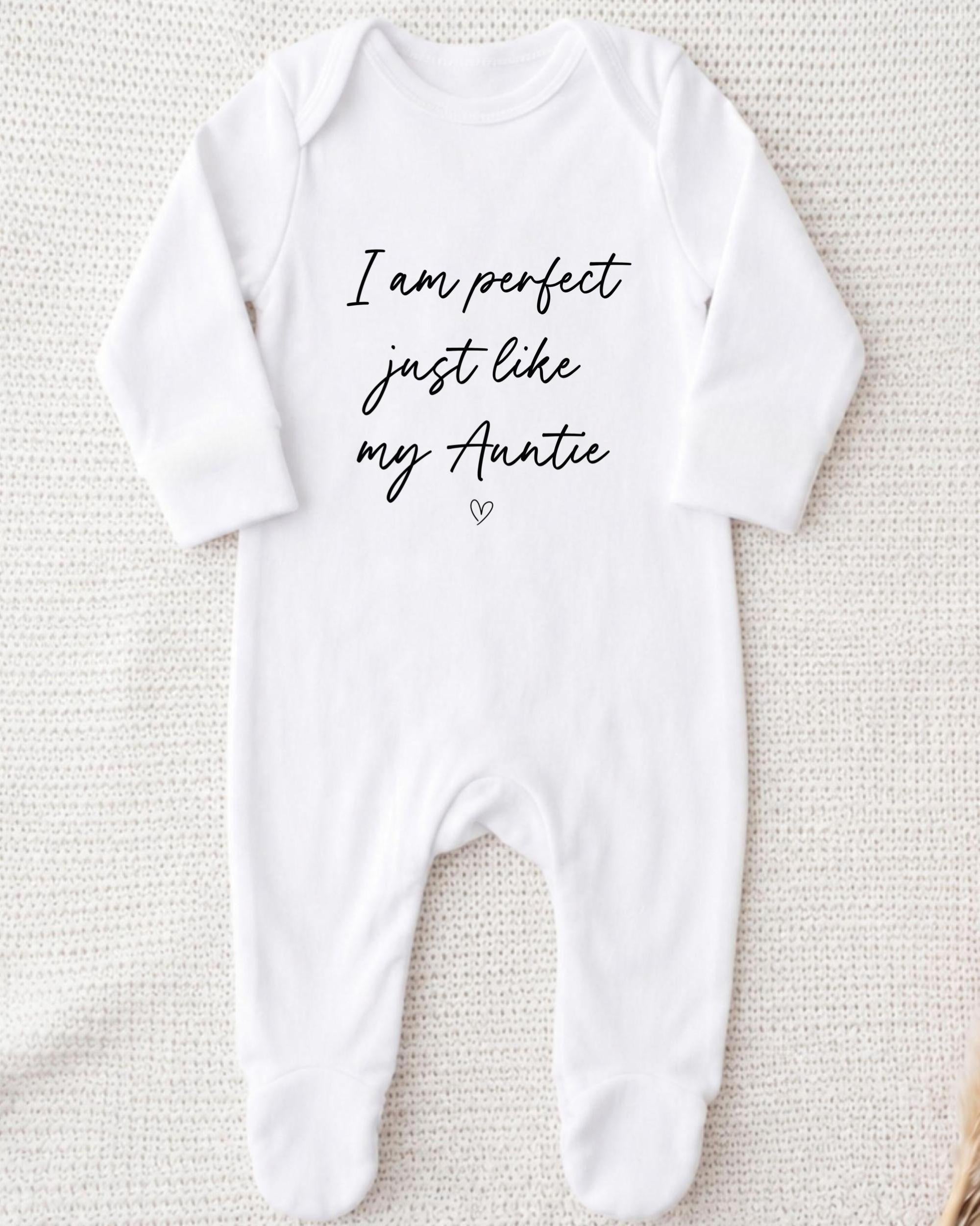 A white onesie with the text "I am perfect just like my Auntie" printed on it.