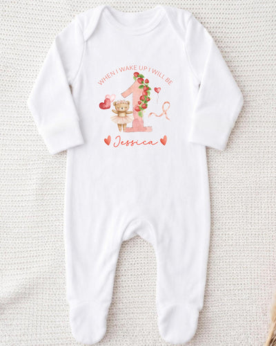 A white bodysuit with a personalized message and a cute illustration of a teddy bear.