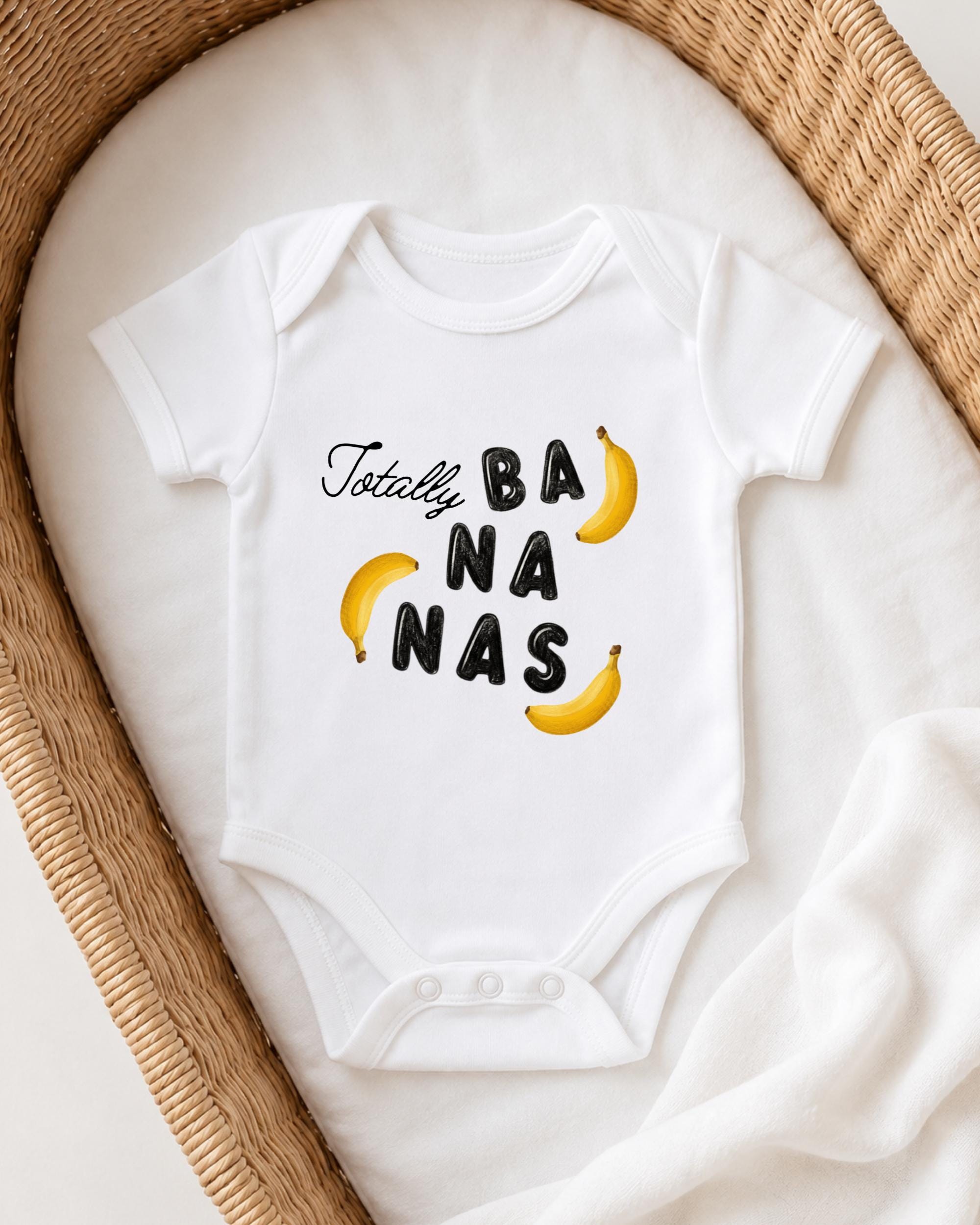 A white onesie with the text "Totally BANANA NAS" printed on it, along with illustrations of bananas.