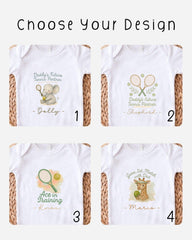 four different baby onesies with tennis-themed designs, each featuring a unique character or animal.