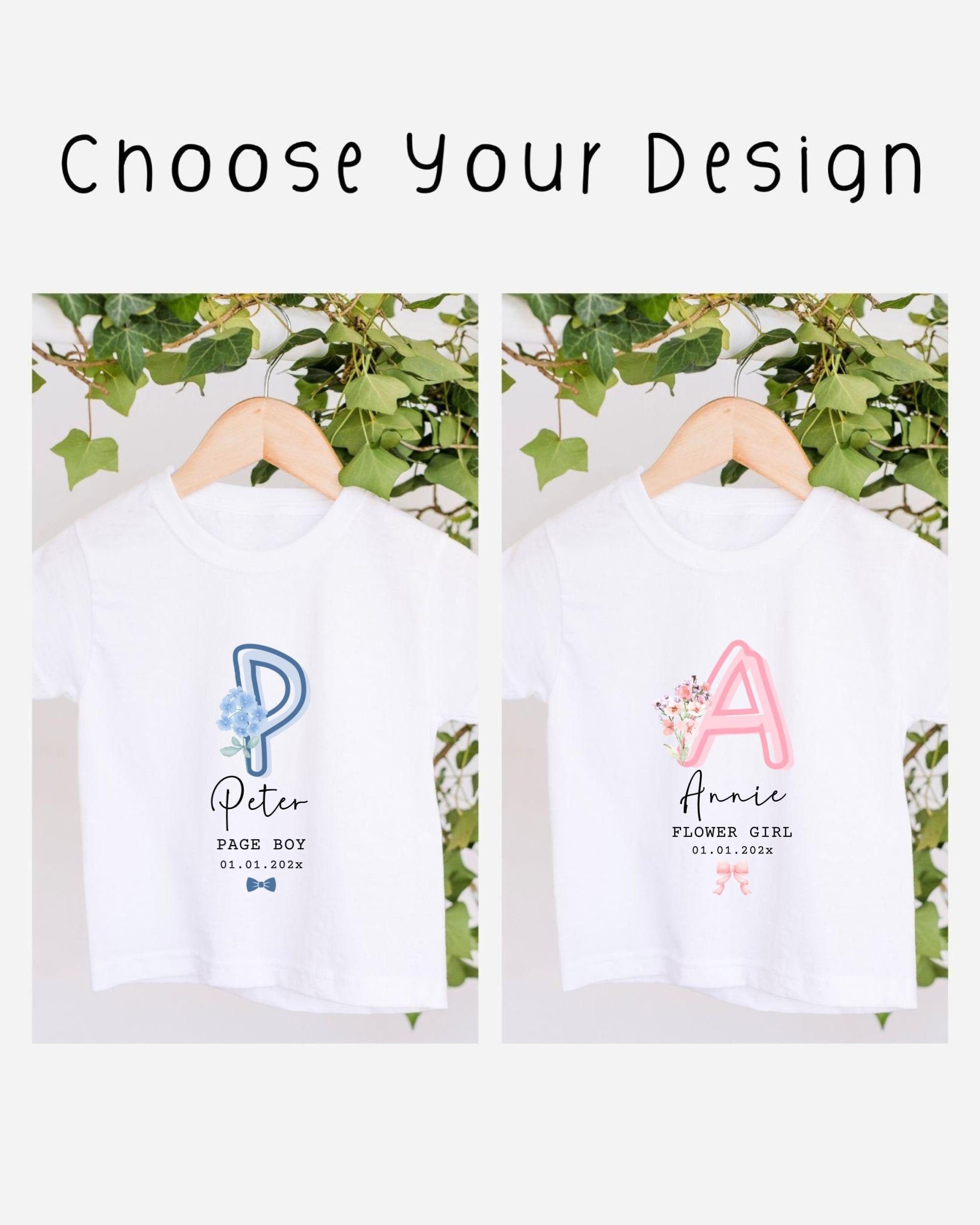 two white t-shirts with personalized text and names printed on them, hanging on a wooden hanger.