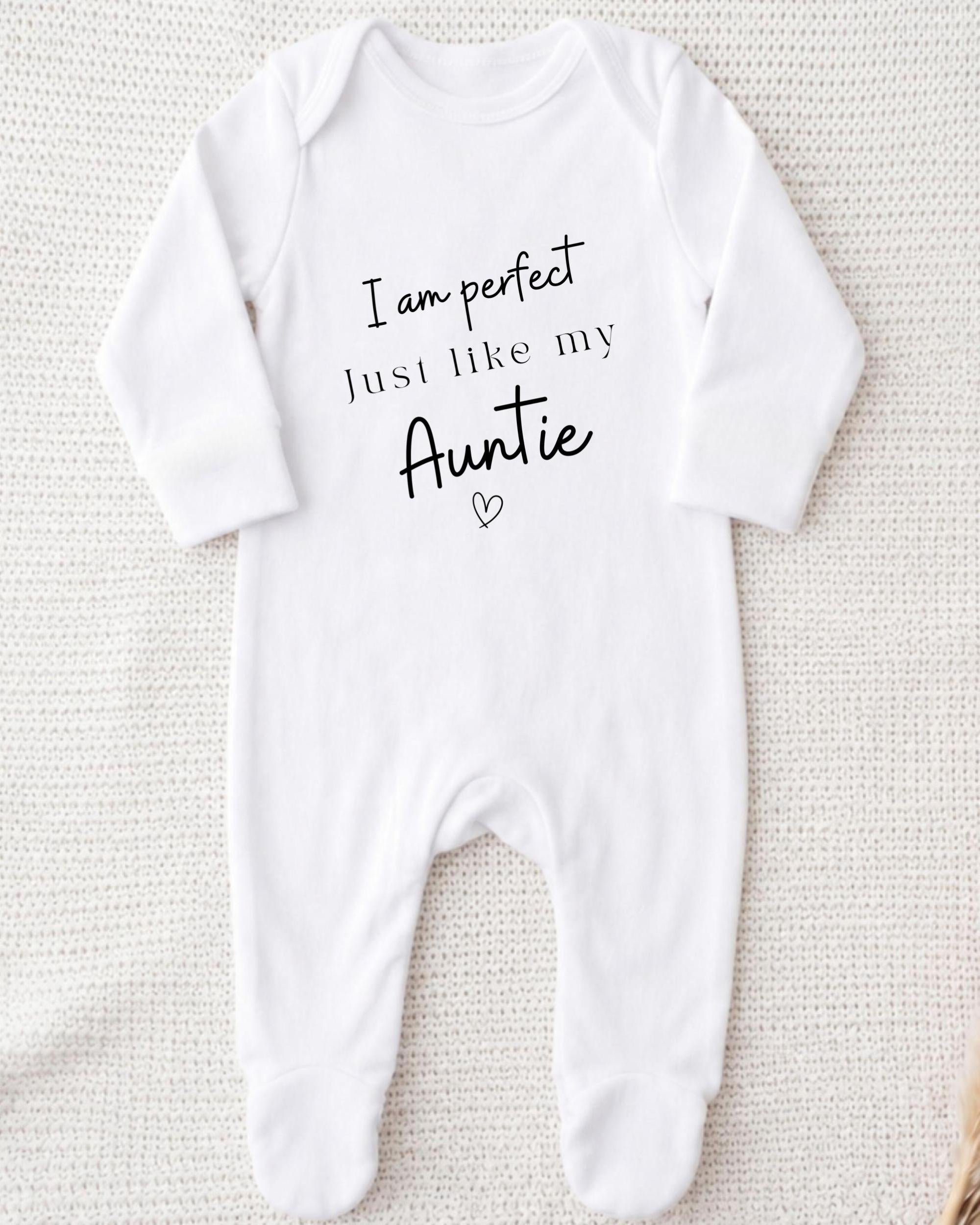A white onesie with the text "I am perfect just like my Auntie" printed on it.