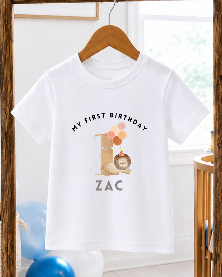 A white t-shirt with a personalized birthday message and a cartoon image of a lion.