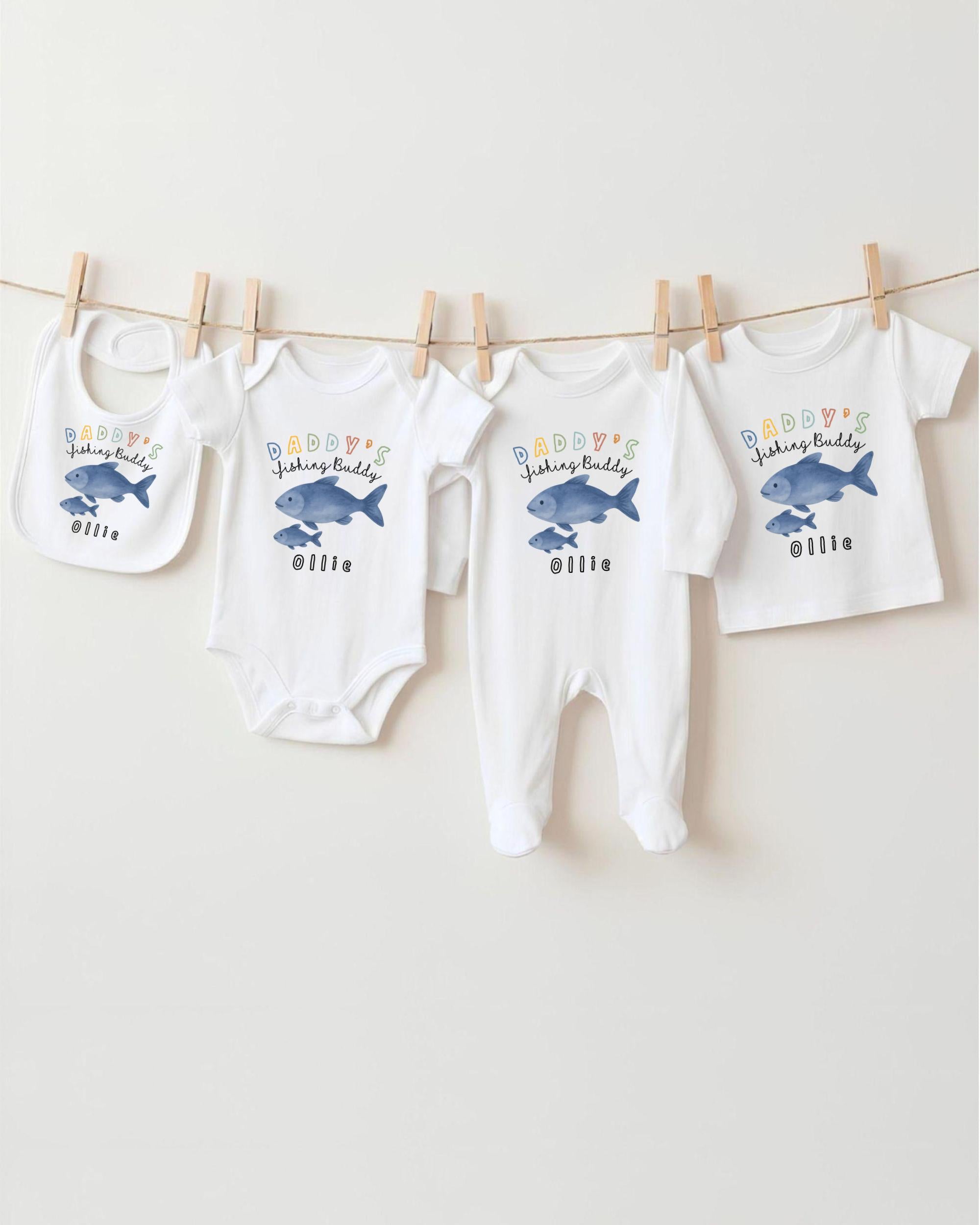 A collection of baby clothes, including onesies and pajamas, hanging on a clothesline.