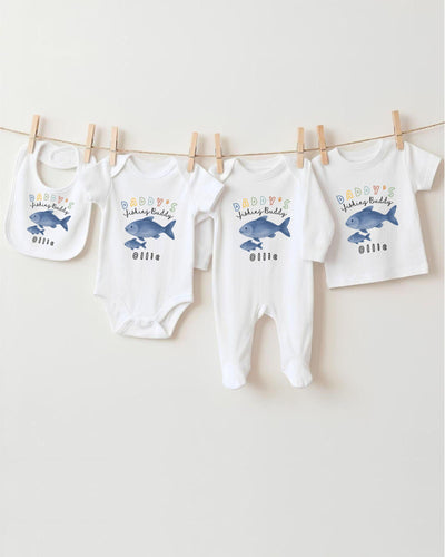 A collection of baby clothes, including onesies and pajamas, hanging on a clothesline.