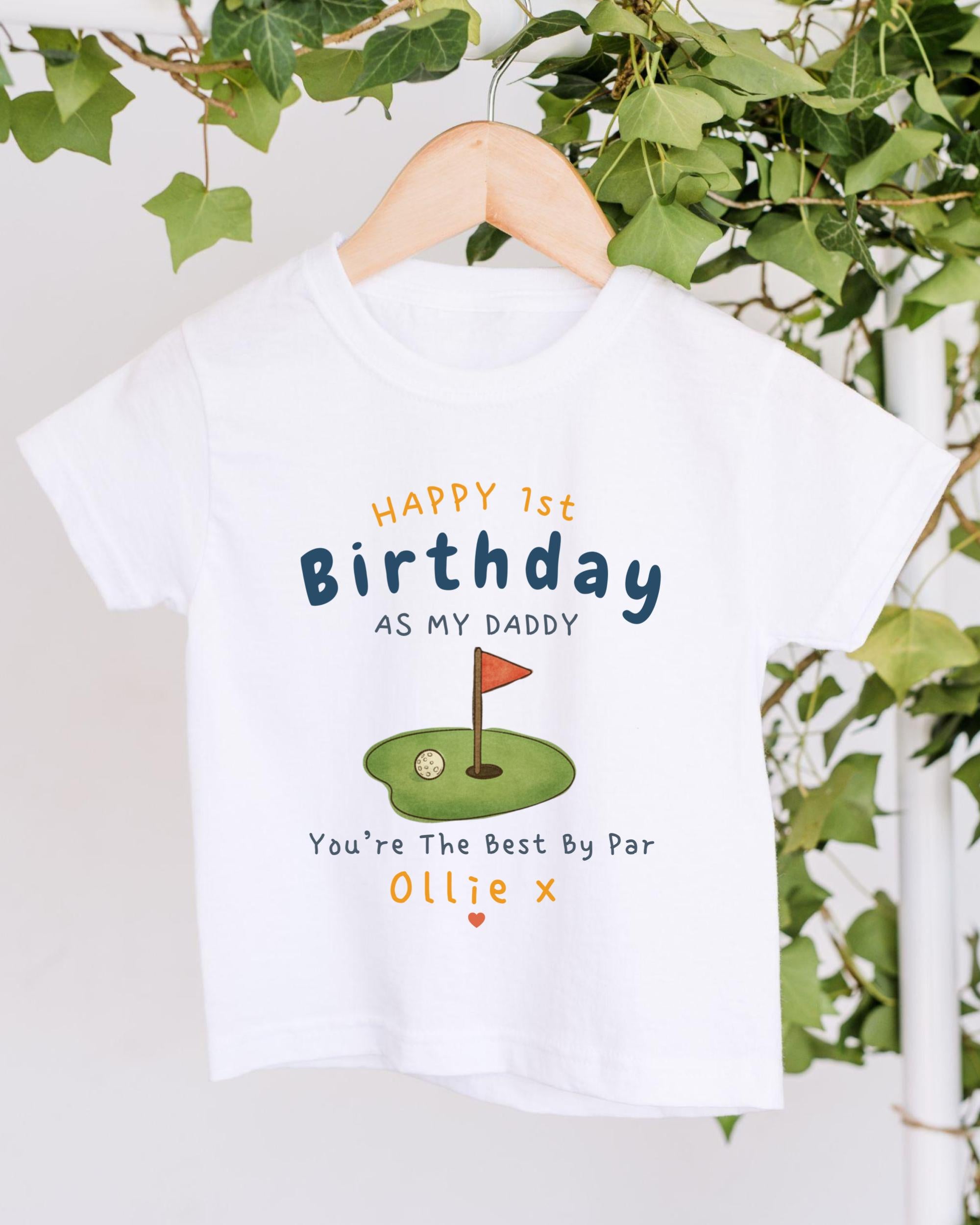 A white t-shirt with a golf hole graphic and text that reads "Happy 1st Birthday as my Daddy You're The Best By Par Ollie X".