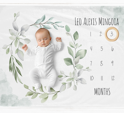 a baby is laying down on a calendar