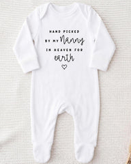 A white onesie with the text "Hand picked by my Nanny in heaven for earth" printed on it.