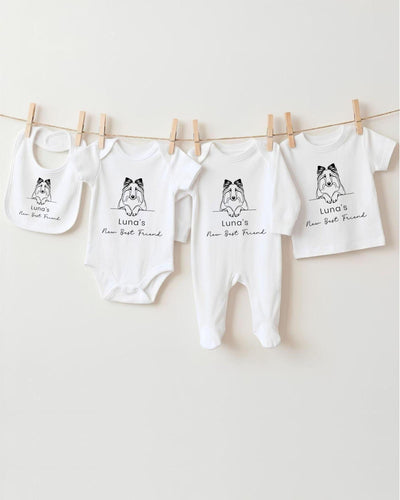 A row of four white baby clothes with black text and illustrations, hanging on a clothesline.