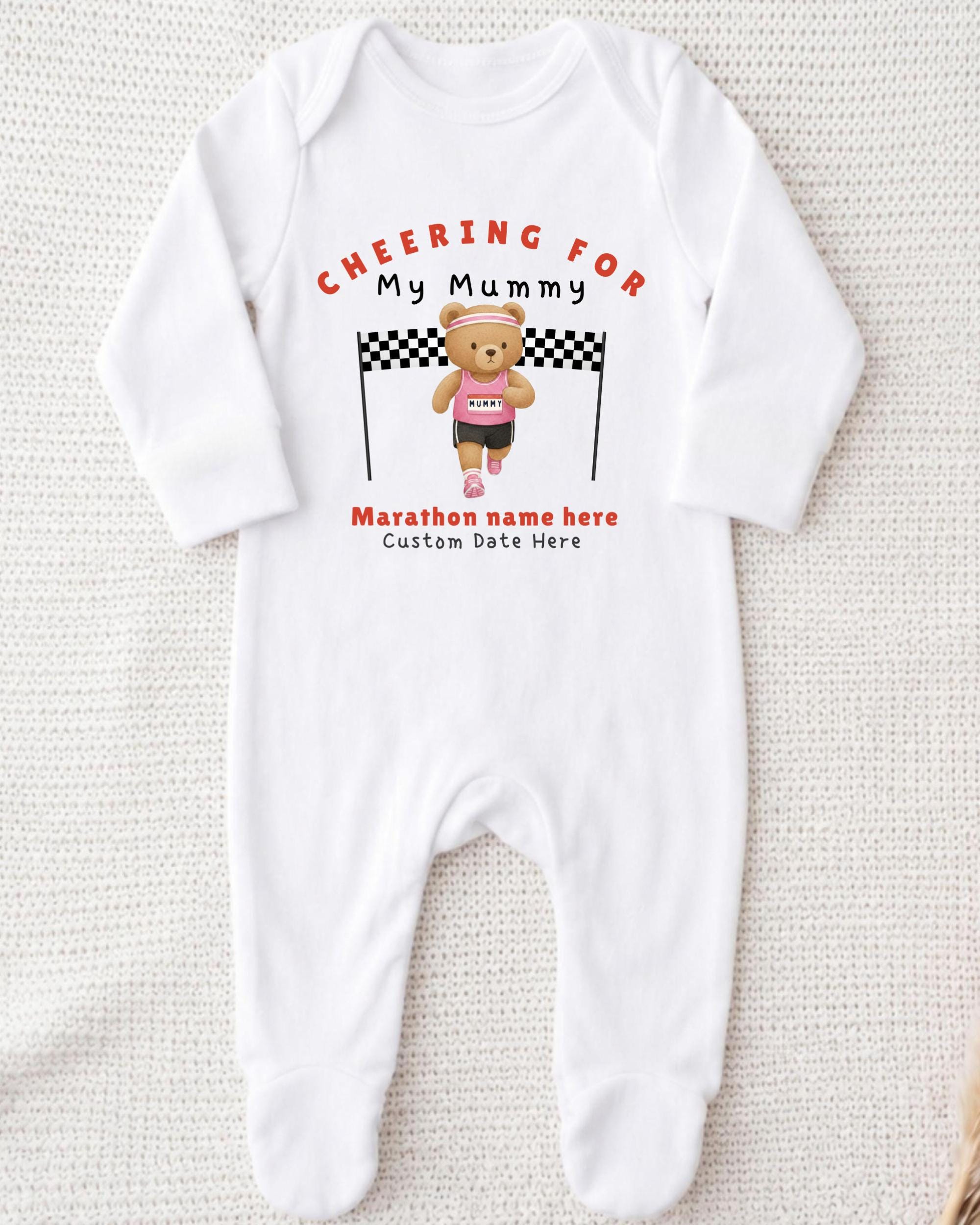 A white onesie with a teddy bear and a running bear printed on it, along with the text "Cheering for My Mummy" and "Marathon name here Custom date here".