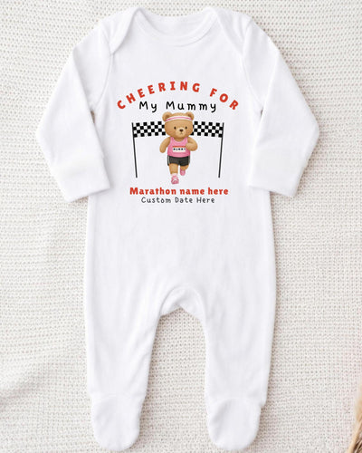 A white onesie with a teddy bear and a running bear printed on it, along with the text "Cheering for My Mummy" and "Marathon name here Custom date here".