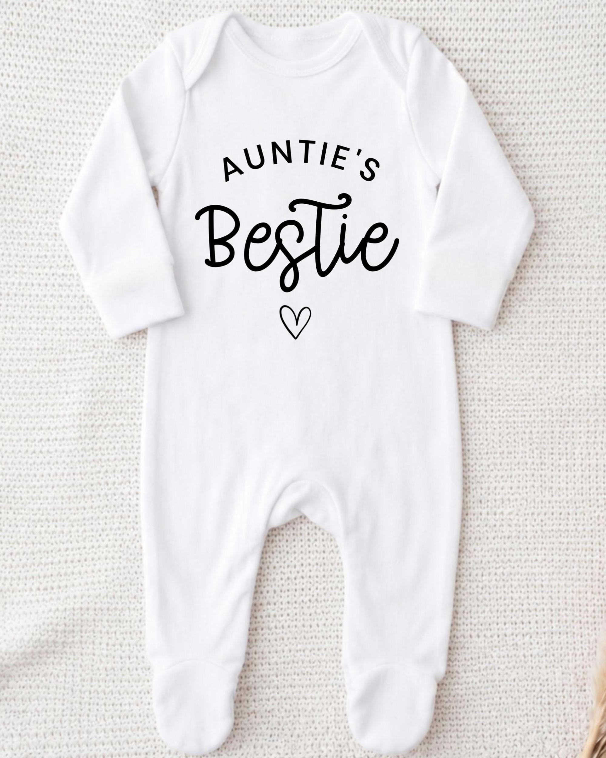 A white onesie with the text "Auntie's Bestie" printed on it.