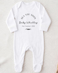 A white onesie with text printed on it, placed on a white background.
