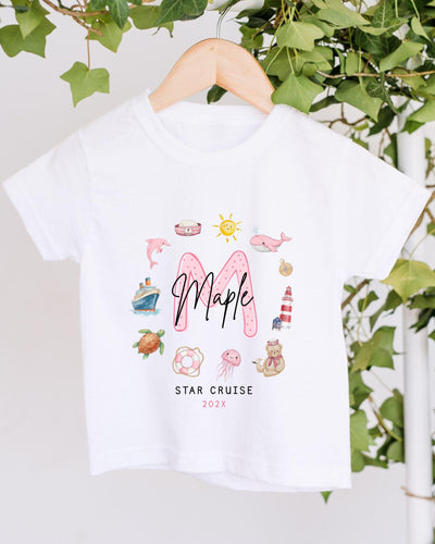 A white t-shirt with a graphic design featuring various nautical and marine-themed illustrations, including a ship, lighthouse, and other sea creatures. The text "Maple" is prominently displayed in the center, and the phrase "STAR CRUISE 2020" is written below the design.