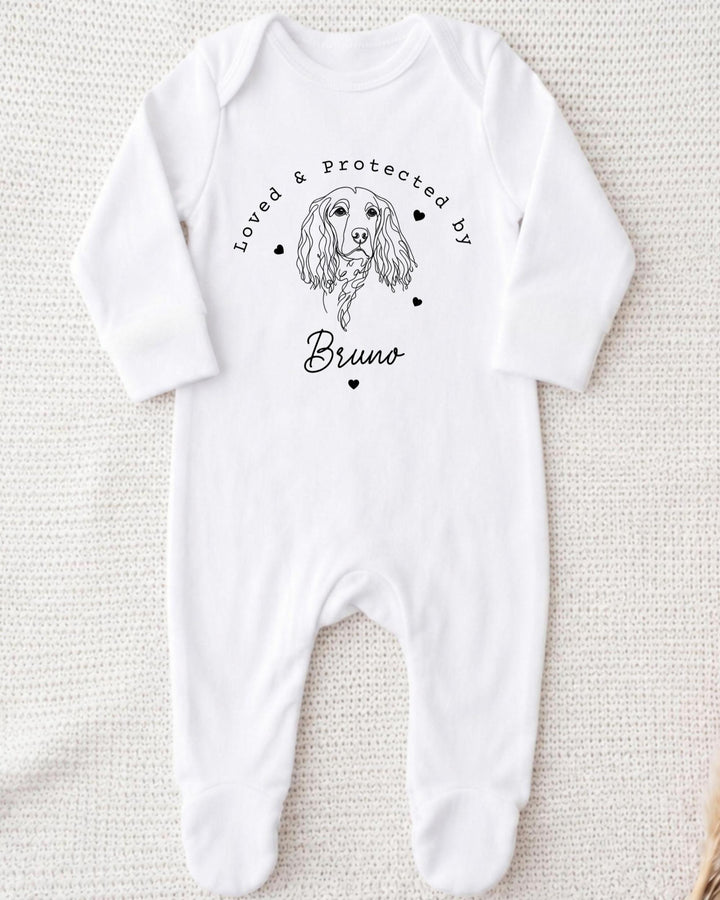 A white bodysuit with a black illustration of a dog and the text "Loved & Protected by Bruno" printed on it.