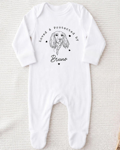 A white bodysuit with a black illustration of a dog and the text "Loved & Protected by Bruno" printed on it.