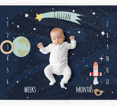 a baby in a space suit laying on the ground