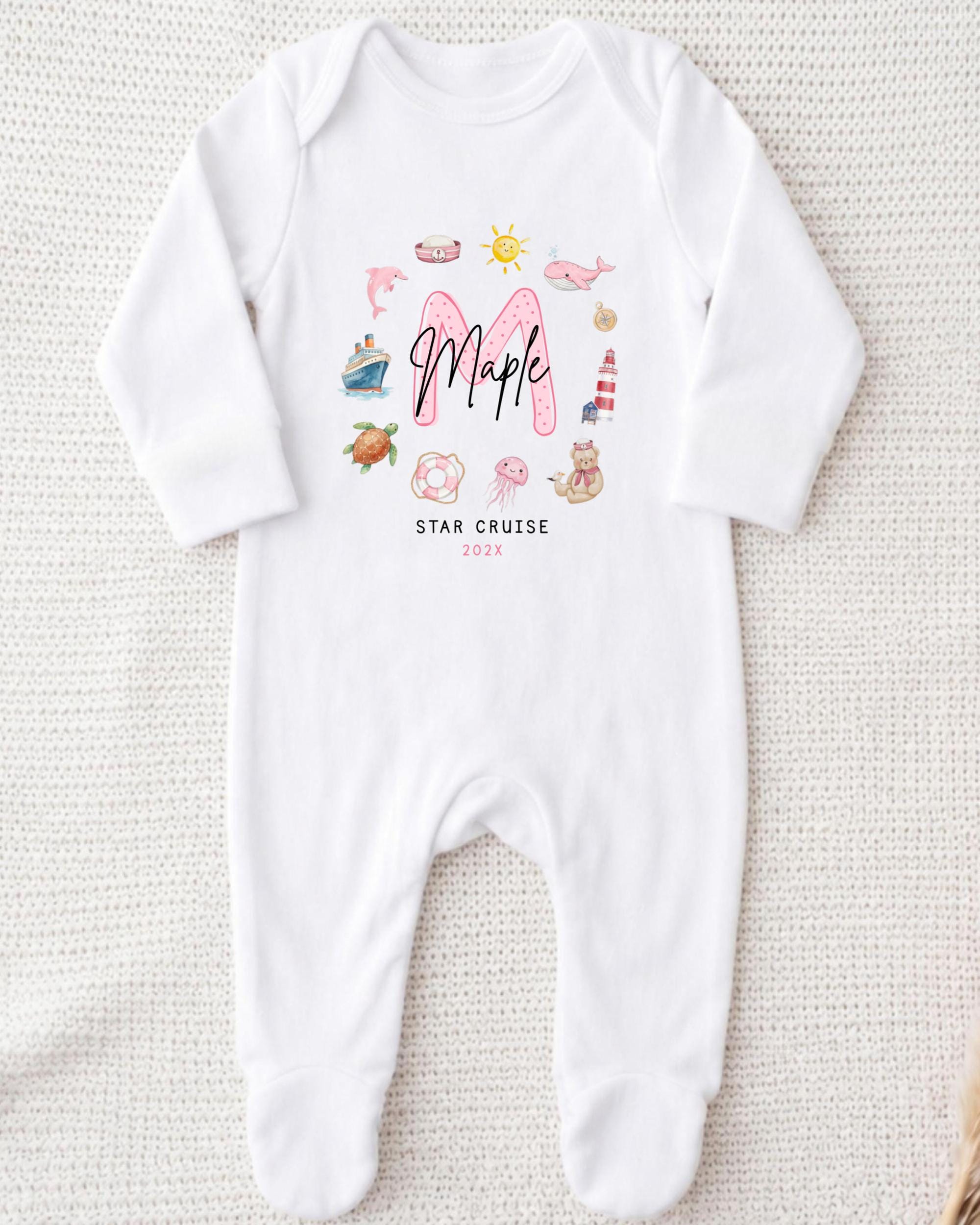 A white onesie with a personalized text and various illustrations printed on it.