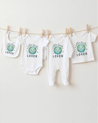 A collection of baby clothes, including onesies and bibs, hanging on a clothesline.