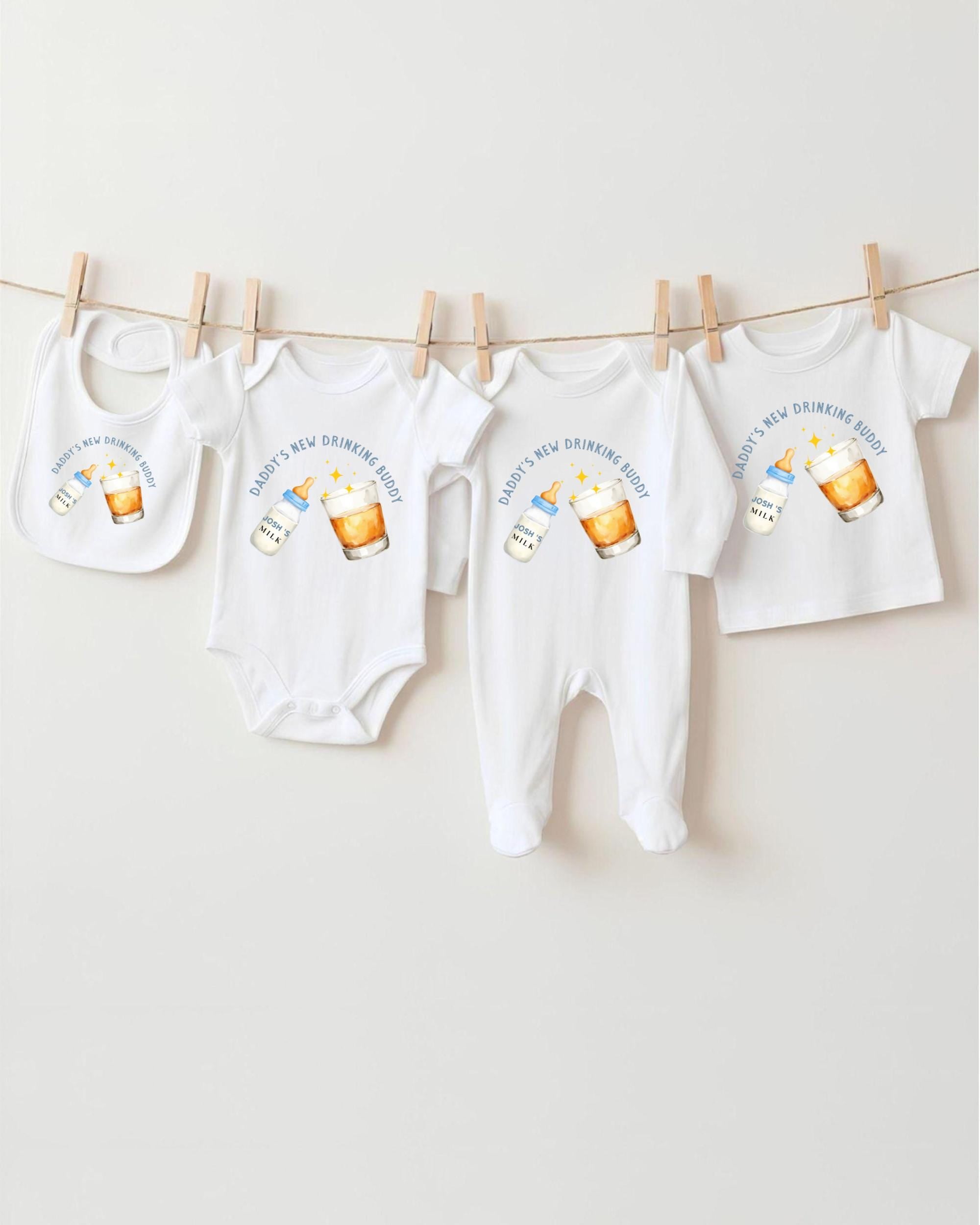 A collection of baby clothes, including onesies and bibs, hanging on a clothesline.