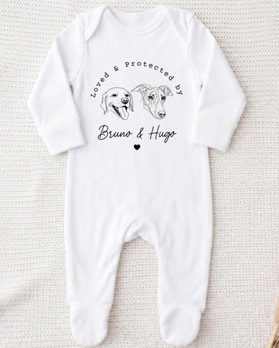 A white bodysuit with a graphic design featuring two dog heads and the text "Loved & Protected by Bruno & Hugo" printed on it.