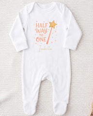 A white onesie with a printed text and a star graphic on it.