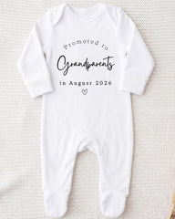 A white onesie with text printed on it, which appears to be a baby onesie.