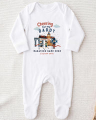 A white onesie with a graphic design on it, featuring a cartoon image of a father and his child, along with text that says "Cheering for my DADDY" and "Marathon Name Here".