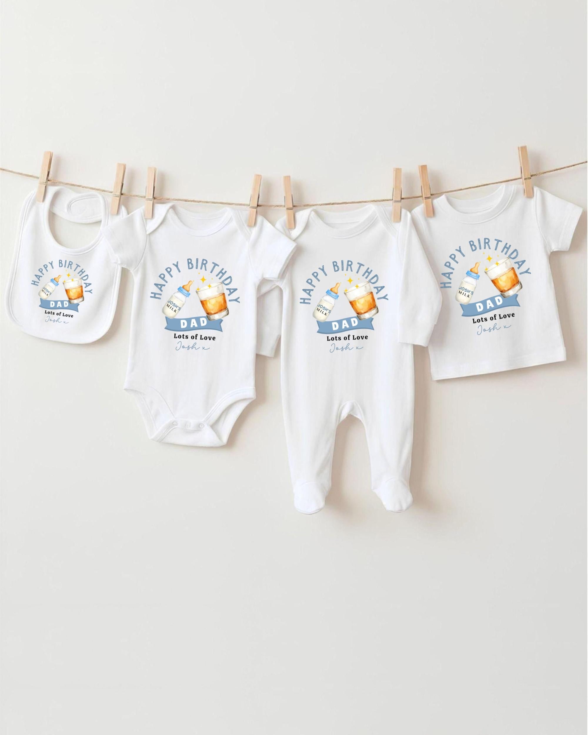 A collection of white baby clothes, including onesies and bibs, hanging on a clothesline.