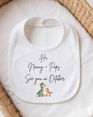 A white bib with a personalized message printed on it, placed on a white cloth.