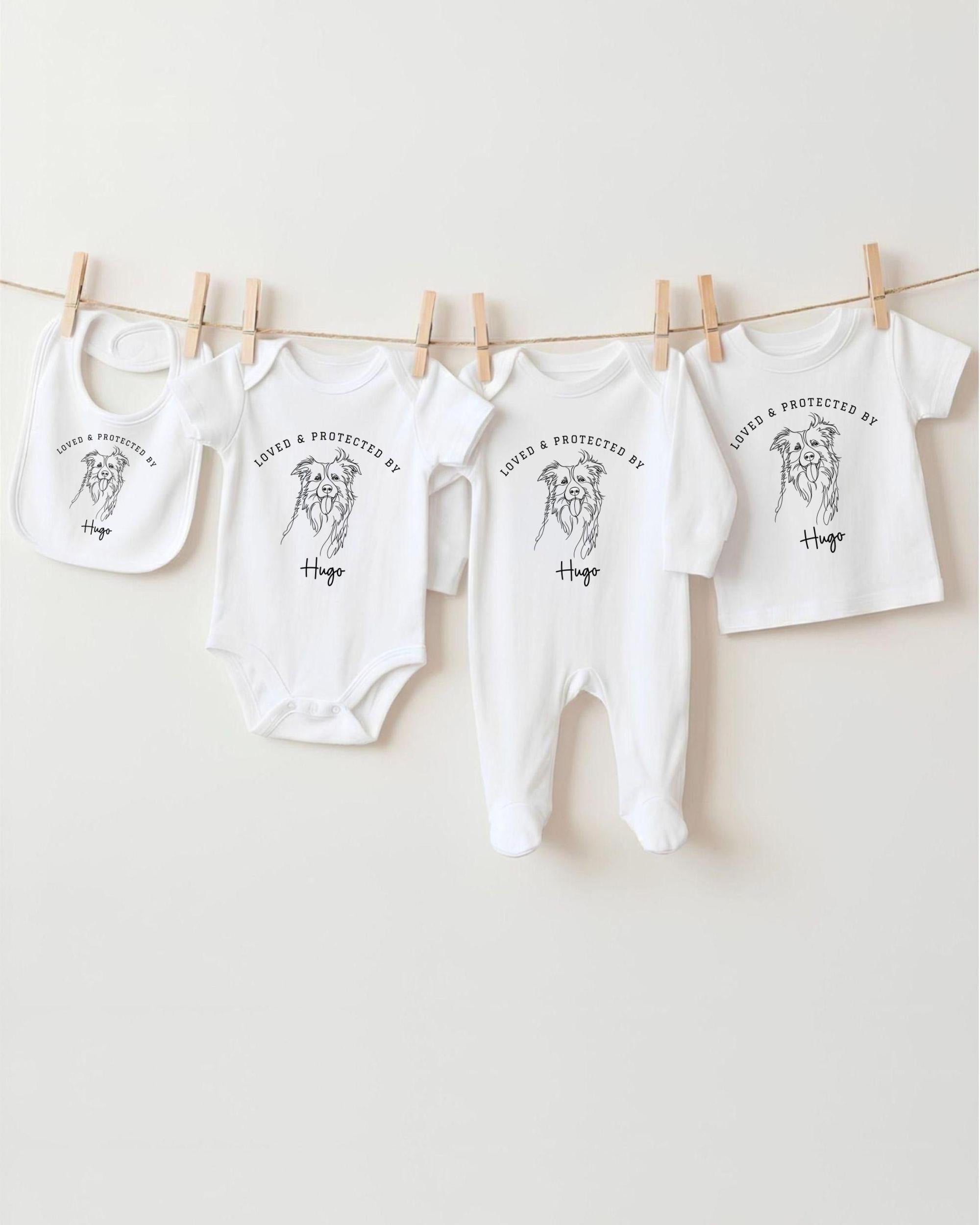 A row of white baby clothes, including onesies and bibs, hanging on a clothesline.