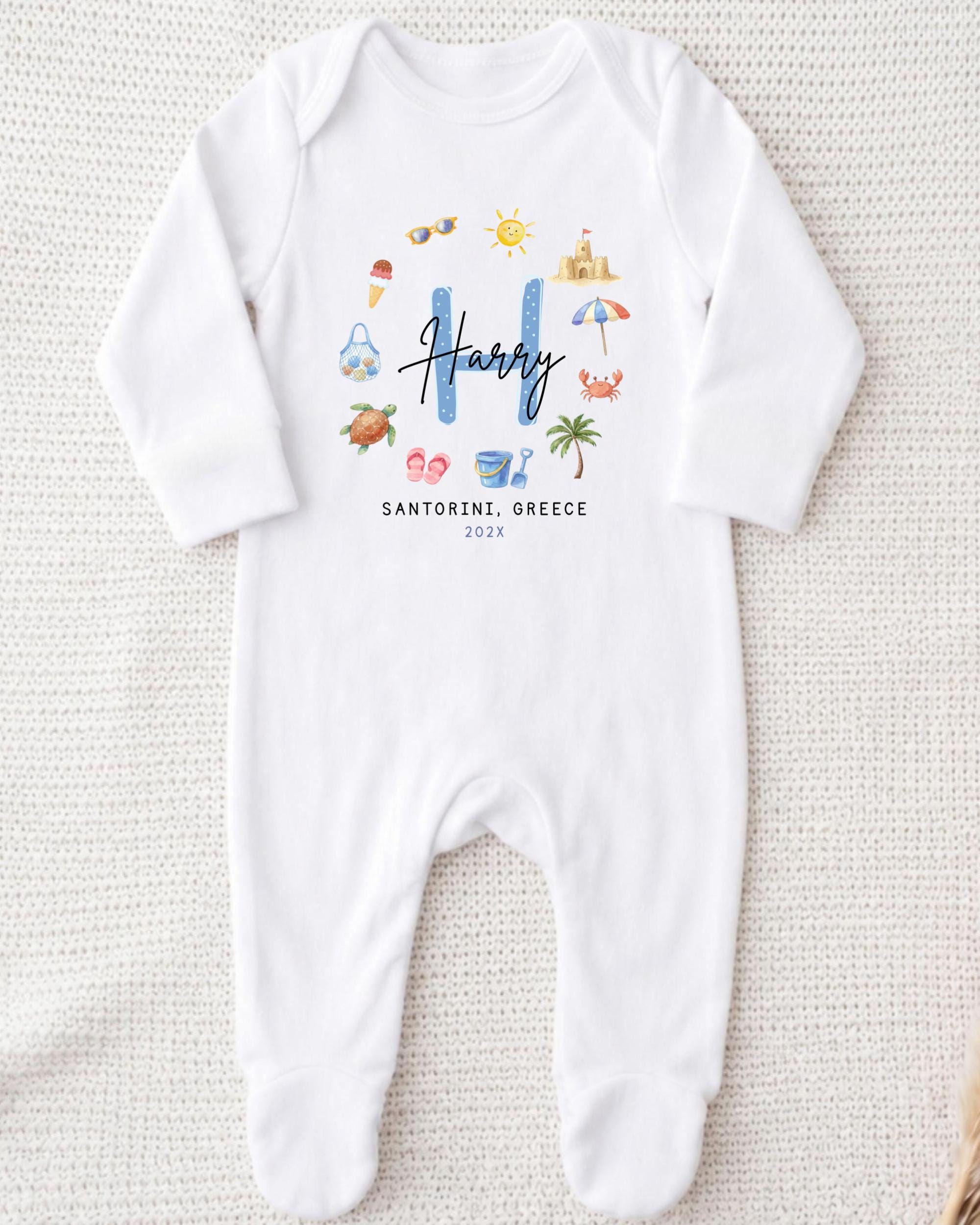 A white onesie with a personalized name and location printed on it.