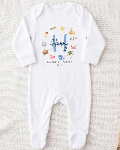 A white onesie with a personalized name and location printed on it.