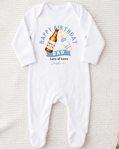 A white onesie with a graphic design on it, featuring a bottle of beer and a baby bottle, along with the text "Happy Birthday Dad Lots of Love Joshi".