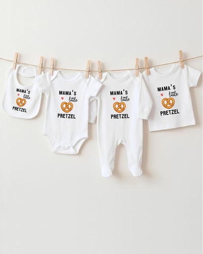 A row of four white baby clothes with the text "MAMA'S LITTLE PRETZEL" printed on them, along with a small pretzel icon.