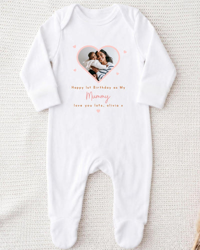 A white onesie with a photo of a mother and child inside a heart shape, along with the text "Happy 1st Birthday as My Mummy, love you late, Olivia x".