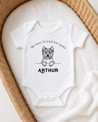 A white baby onesie with a black illustration of a dog and the text "My best friend has paws ARTHUR" printed on it.