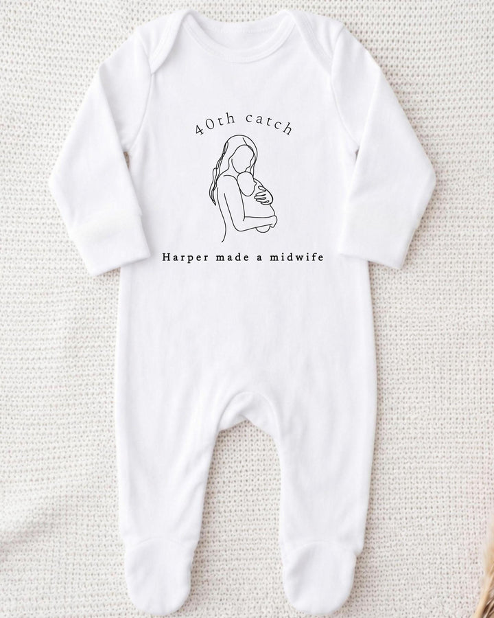 A white bodysuit with a graphic of a woman holding a baby and text that reads "40th catch Harper made a midwife".