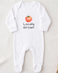 A white onesie with a printed tomato graphic and the text "Locally Grown" printed on it.