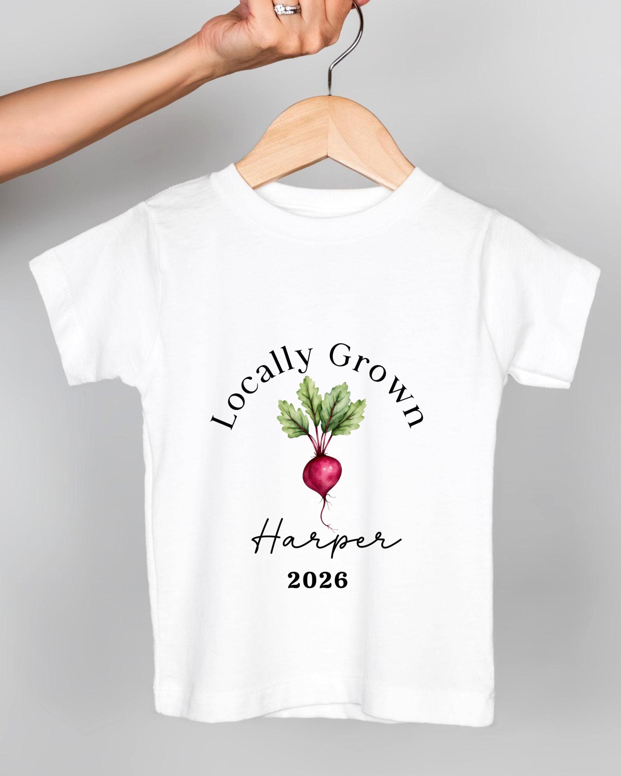 A white t-shirt with a graphic design featuring a red radish and the text "Locally Grown Harper" printed on it.