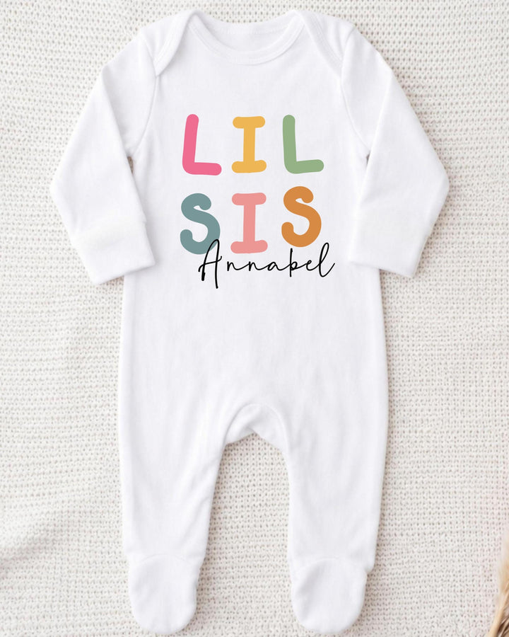 A white bodysuit with the text "LIL SIS Annabel" printed on it.