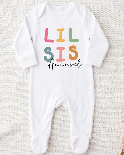 A white bodysuit with the text "LIL SIS Annabel" printed on it.