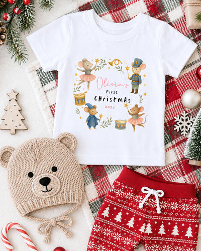 A white t-shirt with a Christmas-themed design, a beige knit hat, red and white patterned shorts, and various Christmas decorations such as a Christmas tree, ornaments, and a snowflake.