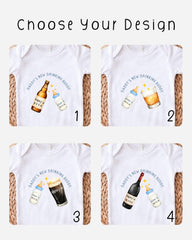 four different designs of t-shirts, each featuring a baby bottle and a glass of beer or wine, along with the text "DADY'S NEW DRINKING BUDDY" printed on them.