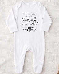 A white onesie with black text that reads "Hand picked by my Nanny in Heaven for earth".